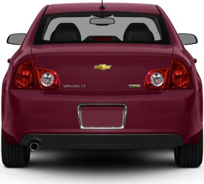 Distinctive taillights and single exhaust on mid-size sedan rear.