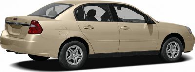 Side and rear view of a four-door beige sedan with distinct wheel design