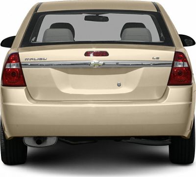 Rear view with tail lights, chrome trim, and exhaust pipe