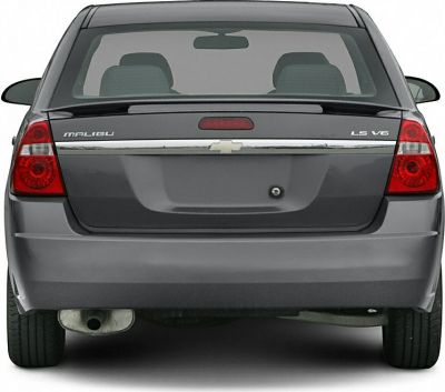 Rear view of a sedan with LS V6 badge and red tail lights