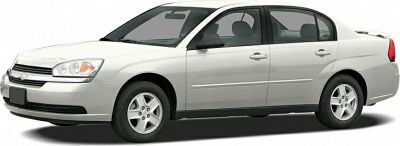 Silver mid-2000s four-door sedan side profile with alloy wheels.