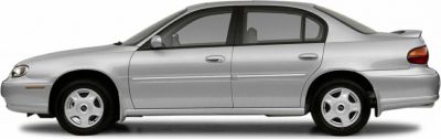 Side profile of a silver mid-size sedan with rear spoiler
