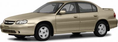 Front side view of a beige four-door sedan with smooth body lines and alloy wheels