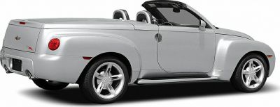 Silver convertible pickup with rounded rear and dual exhaust