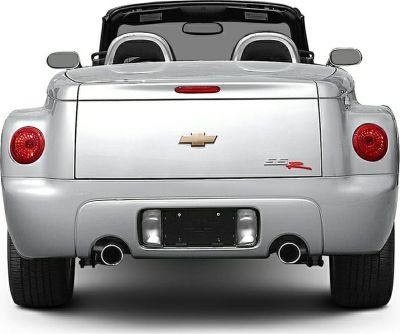 Rear view of a convertible pickup with dual exhaust and round taillights