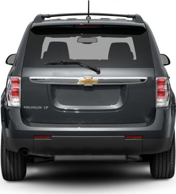 Rear view of SUV with tail lights, rear windshield wiper, and emblem.