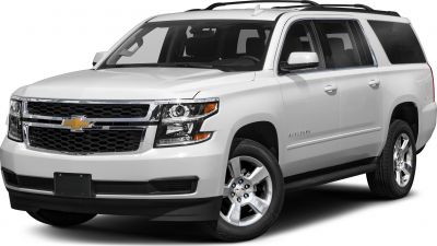 Front three-quarter view of a large full-size SUV with distinct grille and headlights
