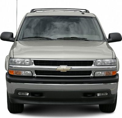 Front view of SUV with grill, headlights, and roof rack.