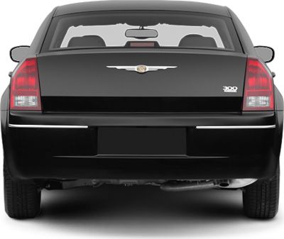 Rear view with distinct tail lights, emblem, and trunk styling