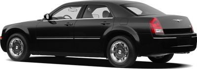 Side profile of a sedan with classic chrome wheels