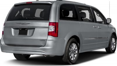 Rear side view of a silver minivan with taillights and sliding door