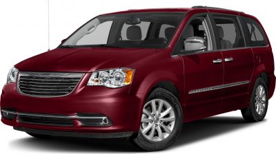 Front side view of maroon minivan with chrome grille and headlights