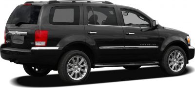 Rear side view of black SUV with chrome wheels and tinted windows