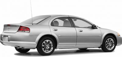 Four-door mid-2000s sedan with chrome wheels and rear antenna