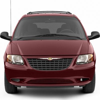 Front view of a minivan with grille, headlights, and roof rack