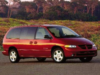 Side profile of a red minivan with sliding door and alloy wheels