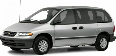 Side view of a silver minivan with sliding doors and classic 1990s design