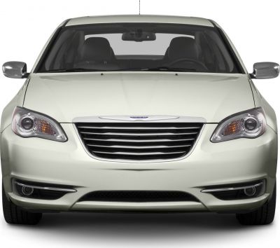 Wide chrome grille and sleek headlights with fog lights on front view