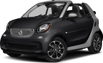 Compact two-seater convertible with open roof and distinctive front grille