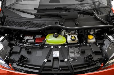 Engine bay with fluid reservoirs and battery compartment