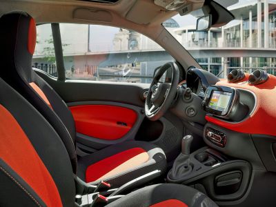 Vibrant two-tone seats and manual gearshift in compact coupe interior