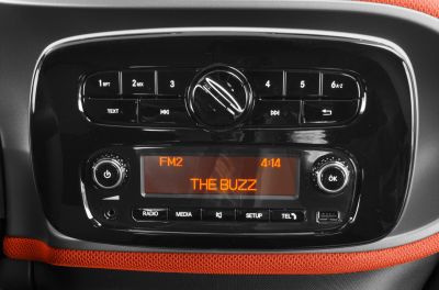 Car radio panel with control buttons and digital display