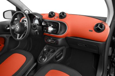 Dashboard and seating upholstery in bold orange and black tones with modern features.
