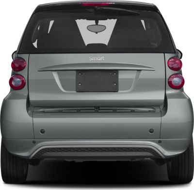 Rear view of a compact hatchback with dual round tail lights and a black rear window.