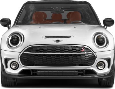 Close-up of front headlights and grille with fog lamps.