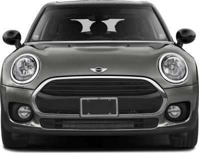 Front view with round headlights, wide grille, and fog lights
