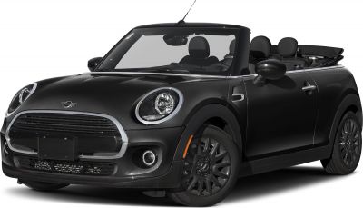 Front-side view of compact convertible with raised headlights and open roof