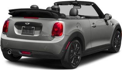 Rear view of a convertible with retracted soft top and illuminated tail lights