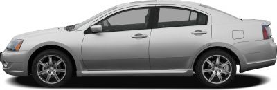 Side profile of a silver sedan with alloy wheels
