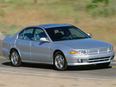 Silver four-door sedan with alloy wheels and sleek front grille