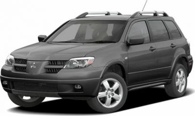 Front side view of SUV with roof rails and distinct headlights