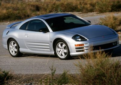 Silver coupe with pop-up headlights and alloy wheels in outdoor setting