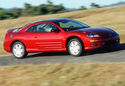 Red coupe side profile with rear spoiler and aerodynamic design