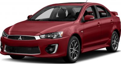 Red sedan with sharp headlights and sporty alloy wheels