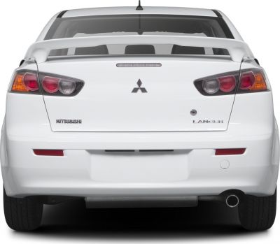 Rear view with taillights, spoiler, and exhaust pipe.