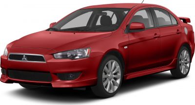 Sporty red sedan with aggressive front bumper, alloy wheels, and rear spoiler