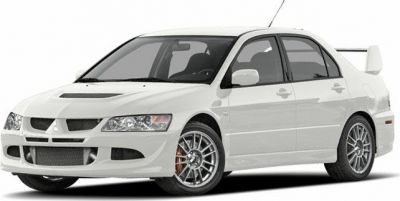 White sporty sedan with large rear spoiler and multi-spoke wheels
