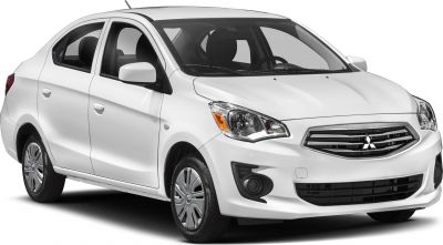 White compact sedan front side profile with prominent grille and headlights