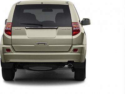 Rear view of an SUV with a distinctive tailgate and spare tire underneath.