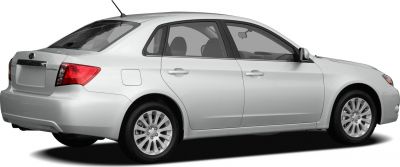 Rear and side profile of a white sedan with alloy wheels