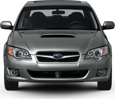 Front view showing hood scoop, headlights, grille, and fog lights.