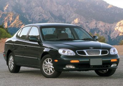 Front and side view of classic 1990s sedan with distinct grille and headlights