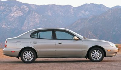 Side profile of a mid-size sedan with alloy wheels on mountainous background