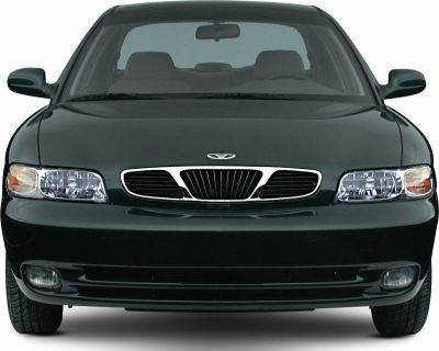 Front of vehicle with distinctive grille and clear headlights.