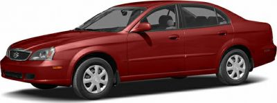 Side profile of a mid-size sedan with four doors and simple wheel covers