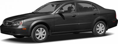 Black four-door sedan front side view with smooth lines and alloy wheels.